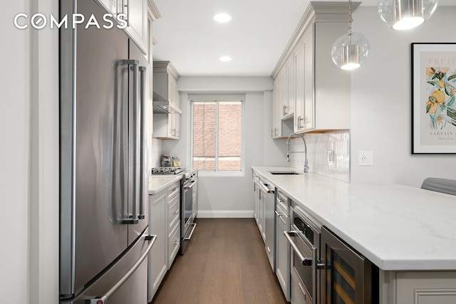 420 E 58th St Unit 14B, New York City, NY 10022 - kitchen with premium appliances, beverage cooler, a sink, dark wood-type flooring, and recessed lighting