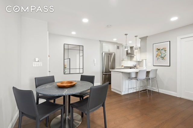 420 E 58th St Unit 14B, New York City, NY 10022 - dining room featuring recessed lighting, dark wood finished floors, and baseboards