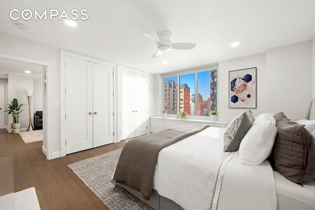 420 E 58th St Unit 14B, New York City, NY 10022 - bedroom with two closets, hardwood / wood-style floors, recessed lighting, ceiling fan, and a view of city