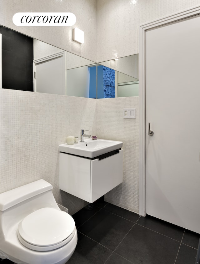 46 Lispenard St Unit 4E, New York City, NY 10013 - bathroom with tile walls, tile patterned floors, vanity, and toilet