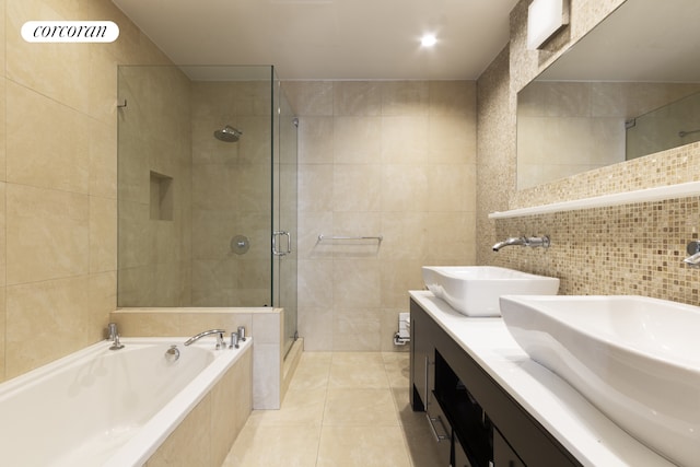 46 Lispenard St Unit 4E, New York City, NY 10013 - bathroom featuring tile walls, a stall shower, a garden tub, tile patterned floors, and double vanity