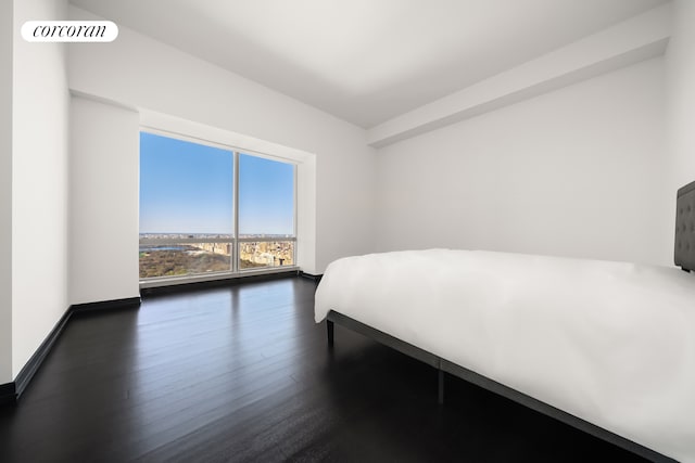 157 W 57th St Unit 56C, New York City, NY 10019 - bedroom with dark wood finished floors, baseboards, and visible vents