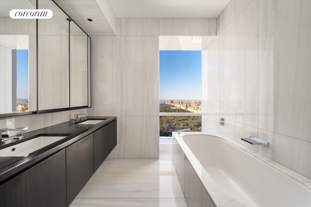 157 W 57th St Unit 56C, New York City, NY 10019 - full bathroom with a bath, a healthy amount of sunlight, and a sink