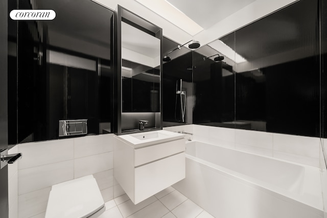 157 W 57th St Unit 56C, New York City, NY 10019 - bathroom featuring walk in shower, vanity, a bathtub, and tile patterned floors
