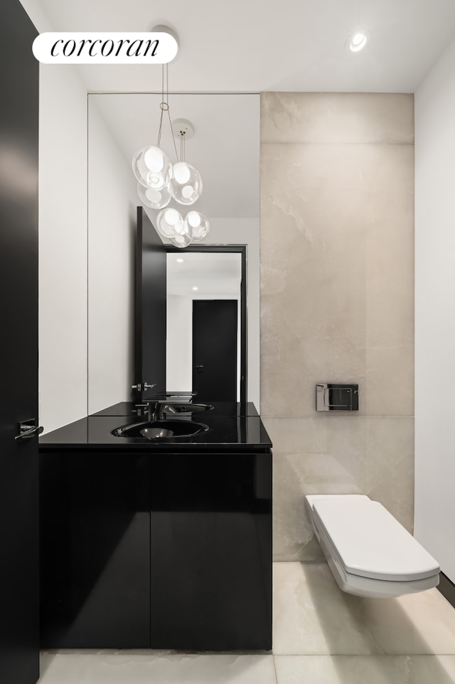 157 W 57th St Unit 56C, New York City, NY 10019 - bathroom with tile walls, toilet, and vanity