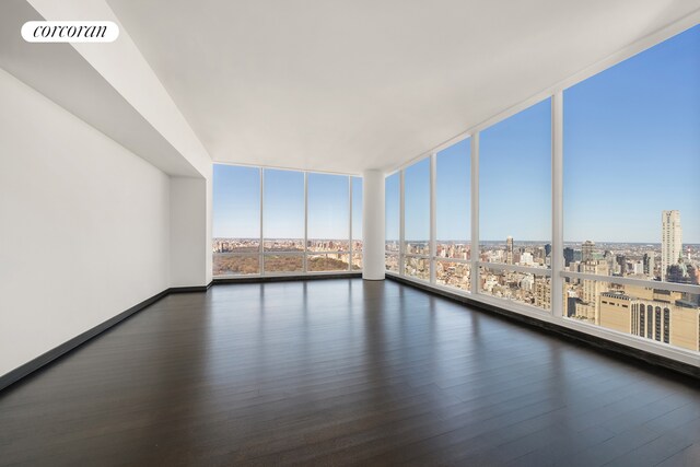157 W 57th St Unit 56C, New York City, NY 10019 - interior space featuring floor to ceiling windows, wood finished floors, visible vents, and a view of city