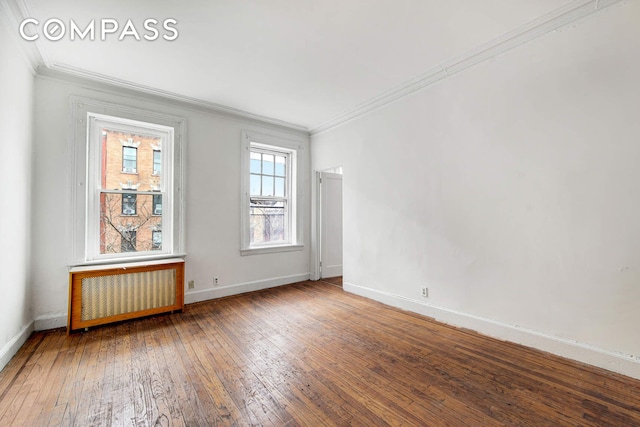 337 E 18th St, New York City, NY 10003 - unfurnished room featuring radiator heating unit, crown molding, baseboards, and wood-type flooring