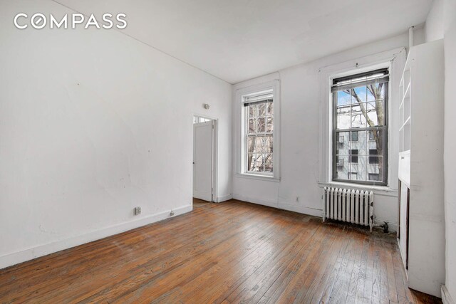 337 E 18th St, New York City, NY 10003 - unfurnished room featuring radiator heating unit, baseboards, and wood-type flooring