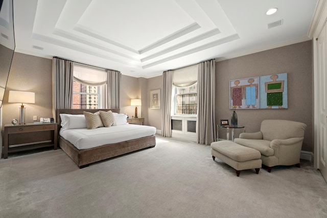 bedroom with a tray ceiling, visible vents, and carpet floors