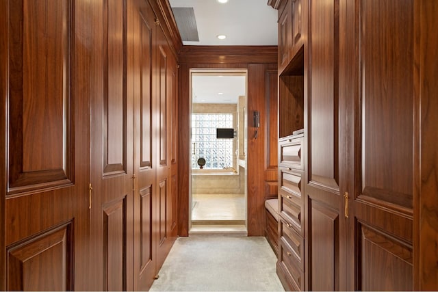 spacious closet featuring light colored carpet