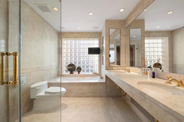 bathroom with a sink, toilet, recessed lighting, and a bath