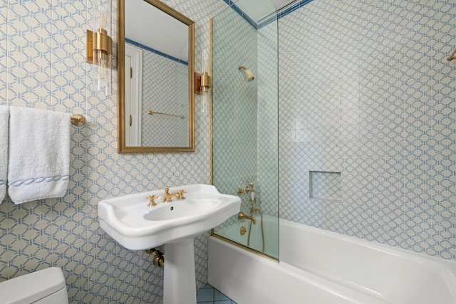 full bathroom featuring toilet, tub / shower combination, and wallpapered walls