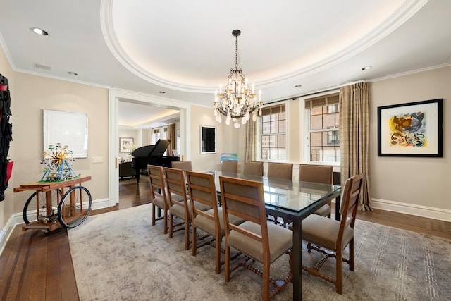 dining space with ornamental molding, baseboards, a notable chandelier, and wood finished floors