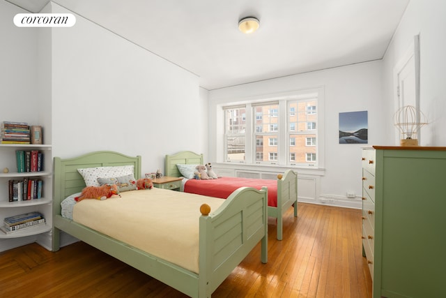 bedroom featuring wood-type flooring and visible vents