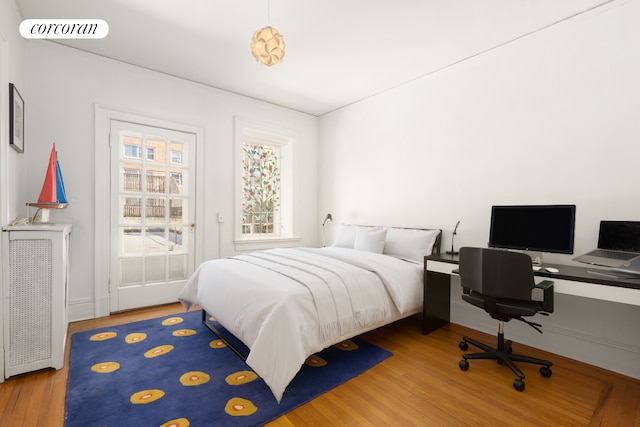 bedroom featuring wood finished floors and visible vents