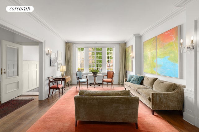 living area with visible vents, crown molding, and wood finished floors