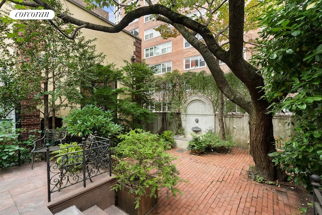 view of community with a patio area and fence