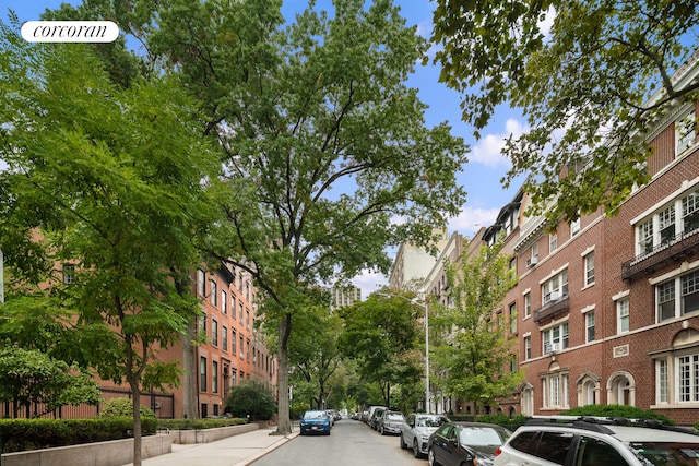 view of street with street lights, sidewalks, and curbs