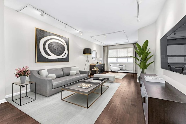 20 E 68th St Unit 5G, New York City, NY 10065 - living area with rail lighting, dark wood-type flooring, and baseboards