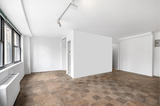 225 E 36th St Unit 11R, New York City, NY 10016 - spare room featuring radiator and stone finish flooring