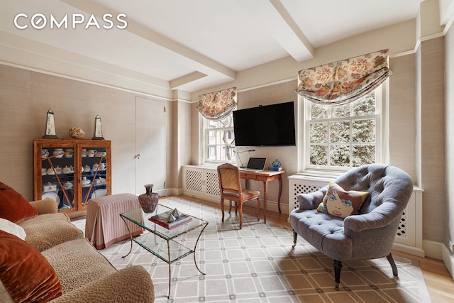 living room with healthy amount of natural light, wood finished floors, and baseboards