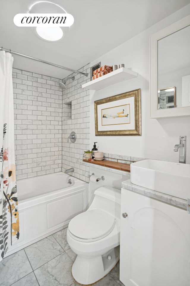 443 W 24th St Unit G, New York City, NY 10011 - bathroom with marble look tile flooring, shower / bath combo with shower curtain, toilet, and vanity