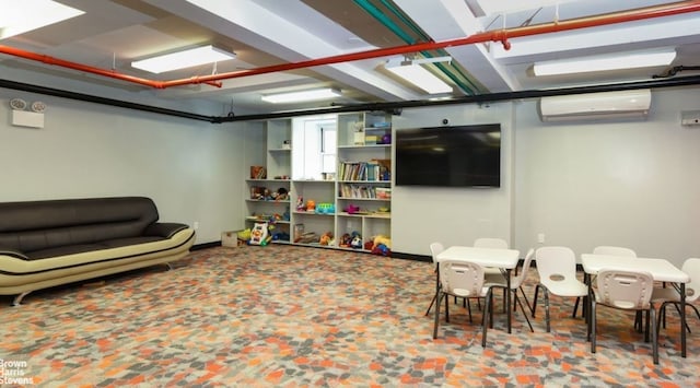 playroom featuring an AC wall unit and baseboards