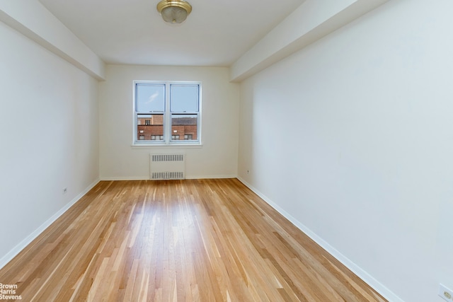 3750 Hudson Manor Ter Unit 6Hw, New York City, NY 10463 - empty room with radiator, light wood finished floors, and baseboards