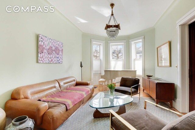 living area with a notable chandelier and light wood-style floors