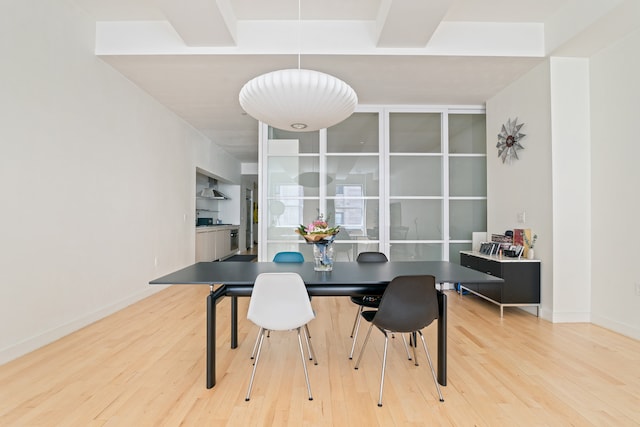 dining space with light wood-style floors and baseboards