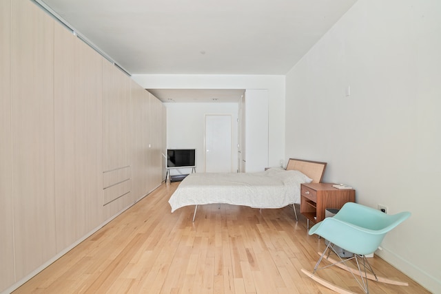 bedroom with light wood-style floors