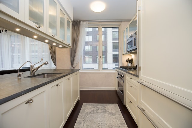 80 Riverside Blvd Unit 5-S, New York City, NY 10069 - kitchen featuring white cabinetry, dark wood-style flooring, stainless steel appliances, glass insert cabinets, and healthy amount of natural light