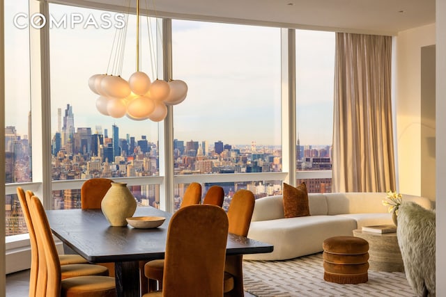 dining space with a view of city, floor to ceiling windows, and plenty of natural light