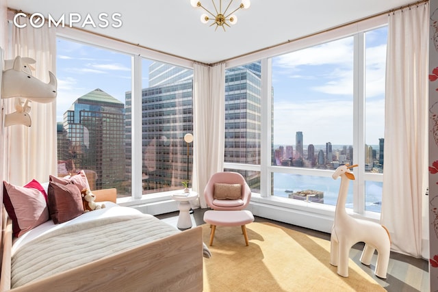 bedroom featuring expansive windows, wood finished floors, and a view of city