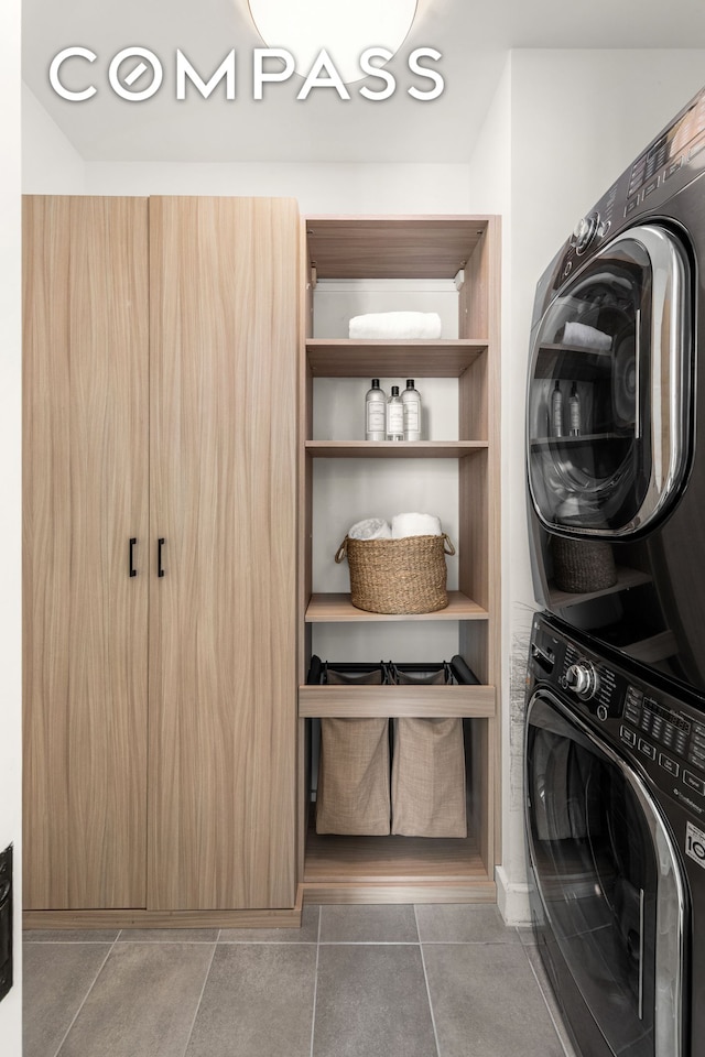 laundry room with stacked washer and clothes dryer and laundry area