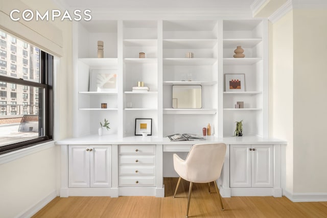 1049 Park Ave Ph, Ph, New York City, NY 10028 - office area featuring built in desk, light wood-style flooring, and baseboards
