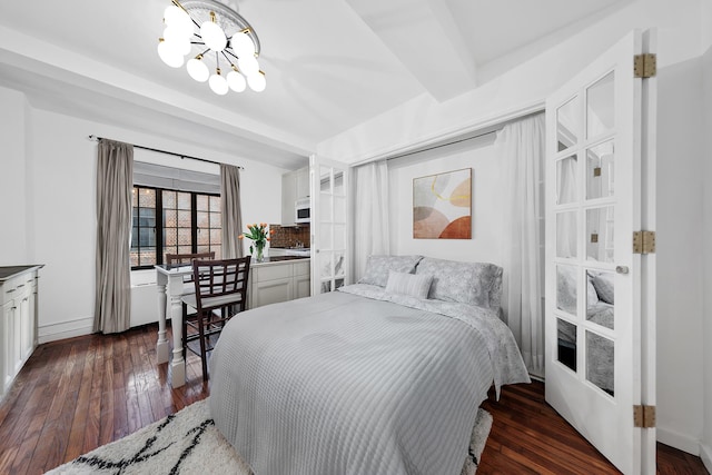 25 Tudor City Pl Unit 1014, New York City, NY 10017 - bedroom featuring a chandelier and dark wood-style flooring