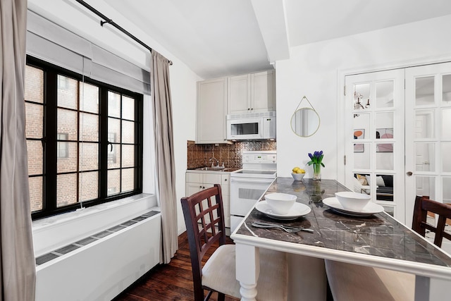 25 Tudor City Pl Unit 1014, New York City, NY 10017 - dining room with radiator and dark wood-style flooring