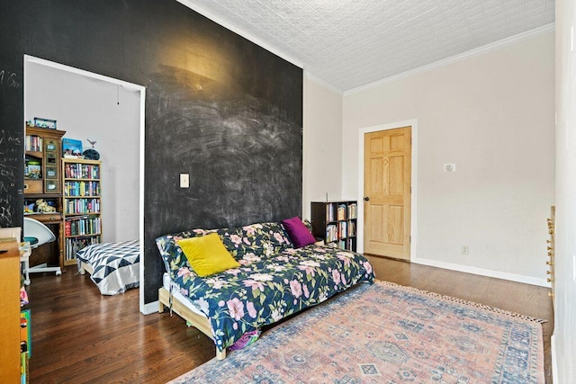 bedroom featuring baseboards, ornamental molding, and wood finished floors