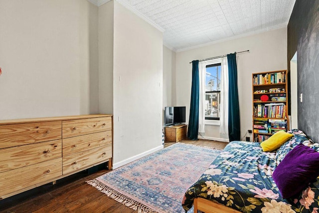 bedroom featuring baseboards, ornamental molding, and wood finished floors