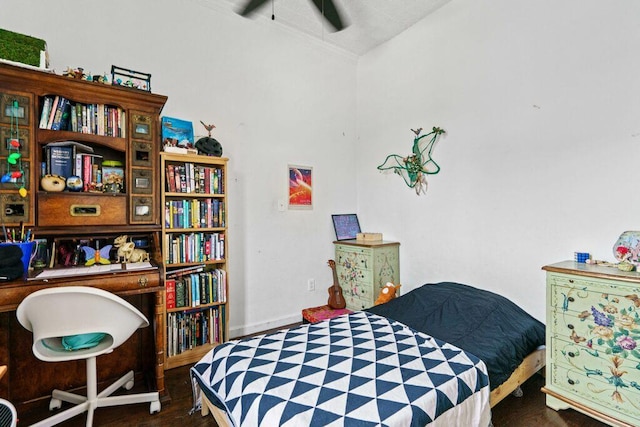 bedroom with baseboards and wood finished floors