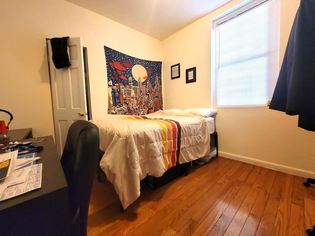 21-05 33rd St Unit 1-G, New York City, NY 11105 - bedroom featuring wood-type flooring and baseboards