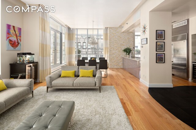 59 John St Unit Ph1, New York City, NY 10038 - living room with wood finished floors, baseboards, and beverage cooler