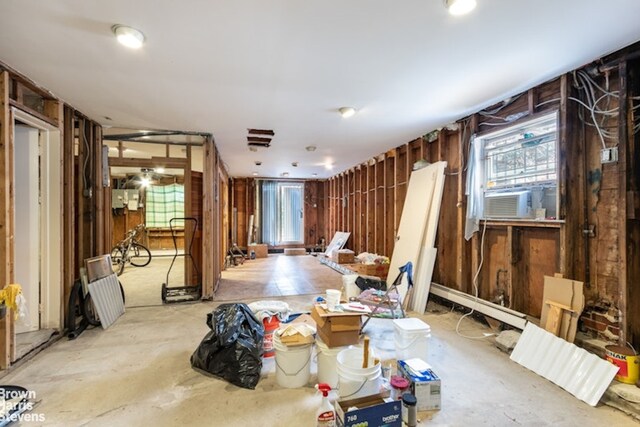 12 Girard St, New York City, NY 11235 - misc room with wooden walls, healthy amount of natural light, concrete flooring, and cooling unit