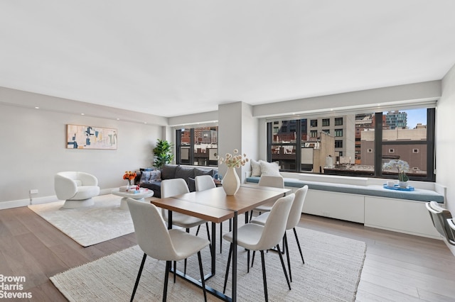 dining room featuring baseboards and light wood-style flooring