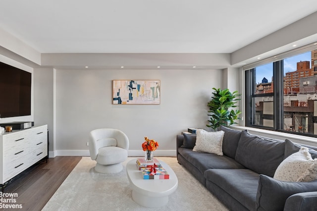 living room featuring dark wood-style flooring, baseboards, and recessed lighting