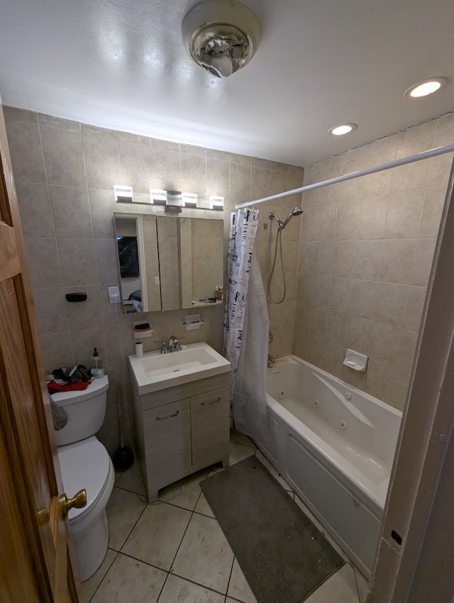 bathroom featuring tile patterned flooring, vanity, shower / tub combo with curtain, toilet, and tile walls