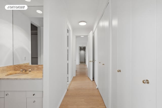 100 United Nations Plz Unit 35E, New York City, NY 10017 - corridor with a sink, light wood-style flooring, and baseboards