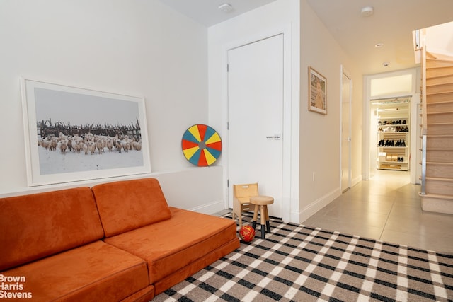 tiled living area featuring baseboards