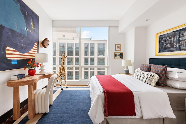 bedroom with multiple windows and carpet